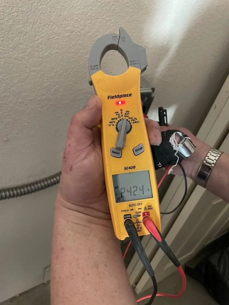 Voltage testing with clamp meter during Ceiling Fan Installation in Fort Dodge
